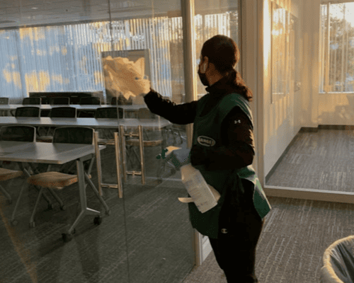 Rangel crew member cleaning glass surfaces