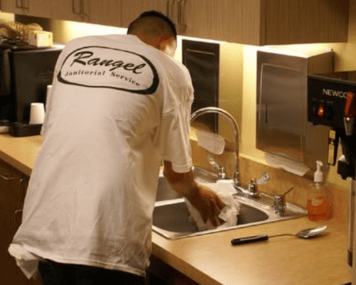 Rangel crew member cleaning restroom facilities