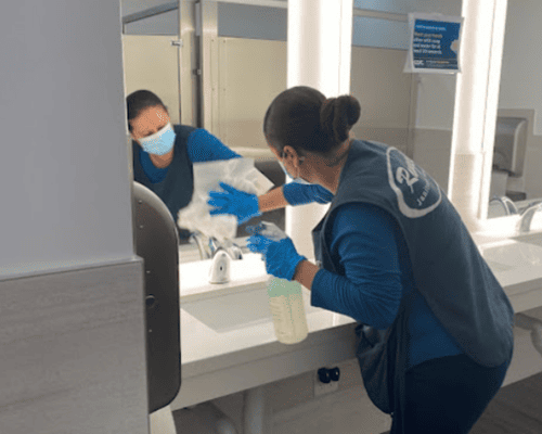 Team members sanitizing office surfaces