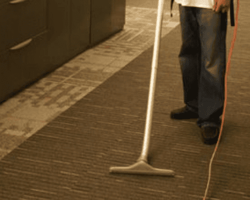 Rangel crew member dusting ceiling fixtures